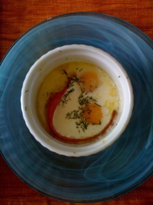 Baked eggs with bacon and dill